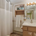 Bright bathroom featuring a functional layout with ample storage and a crisp, clean ambiance.