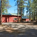30'x40' shop with a 30'x16.5' RV bay and two additional 22'x14' rooms. The 2-car oversized garage has an insulated storage area with baseboard heat. Outside is a 12'x6' shed and a 16'x6' covered wood storage area. The detached pump house/greenhouse is 12'x8'.