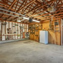 The 2-car oversized garage has heated storage, dedicated wood storage, and a storage room. Plus exterior shed and wood storage.