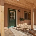 Welcoming entryway with a covered porch and well-maintained landscaping, perfect for relaxing outdoors.
