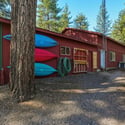 30'x40' shop with a 30'x16.5' RV bay and two additional 22'x14' rooms. The 2-car oversized garage has an insulated storage area with baseboard heat. Outside is a 12'x6' shed and a 16'x6' covered wood storage area. The detached pump house/greenhouse is 12'x8'.
