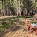 Enjoy peaceful woodland views from the spacious deck, perfect for relaxation and outdoor gatherings.