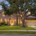 Stunning two-story brick home featuring spacious interiors and lush landscaping, perfect for family living.