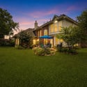 Spacious backyard oasis featuring lush landscaping and inviting outdoor seating, perfect for gatherings and relaxation.