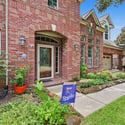 Beautifully landscaped entryway welcomes you to this spacious brick home, featuring ample natural light and modern design.
