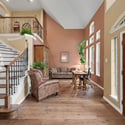 Welcoming entryway with spacious layout, featuring grand staircase and abundant natural light throughout.