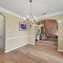 Inviting entryway with beautiful hardwood floors and archways, leading to spacious living areas filled with natural light.