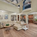 Spacious open living area features high ceilings, modern finishes, and a seamless flow to the kitchen.