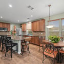 Spacious kitchen with modern appliances, ample counter space, and a cozy breakfast nook for casual dining.