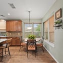 Bright and inviting kitchen features modern appliances, rich cabinetry, and a cozy dining space with natural light.