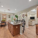 Spacious open-concept kitchen features modern appliances, abundant cabinetry, and connects seamlessly to the inviting dining area.