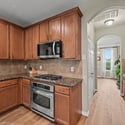 Contemporary kitchen featuring wood cabinets, granite countertops, stainless steel appliances, and an inviting open layout.