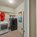 Spacious laundry room features modern appliances and convenient storage, ideal for efficient household management.