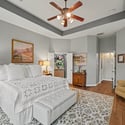 Spacious bedroom featuring vaulted ceilings, natural light, and an inviting layout for relaxation and comfort.