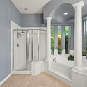 Bright and spacious bathroom featuring a walk-in shower, soaking tub, and large windows for natural light.