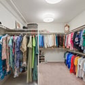 Spacious walk-in closet featuring ample storage for an extensive wardrobe and organized display options.