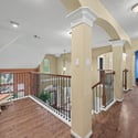 Spacious hallway features attractive architecture and natural light, connecting various living areas throughout the home.
