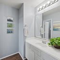 Bright and inviting bathroom featuring contemporary decor, ample counter space, and modern lighting for a refreshing ambiance.
