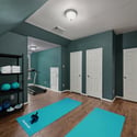 Discover a versatile workout space featuring ample storage and a treadmill, perfect for home fitness enthusiasts.