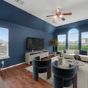 Modern living space with high ceilings, large windows, and an inviting layout perfect for relaxation and entertainment.