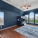 Spacious bedroom featuring a unique bunk bed setup and large windows for ample natural light.