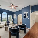 Modern living space featuring unique blue walls, ample natural light, and an inviting open layout.
