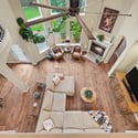 This spacious living area features high ceilings, abundant natural light, and a cozy fireplace for relaxation.