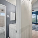 Bright and airy bathroom leads to a spacious living area with abundant natural light and scenic views.