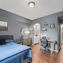 Bright and spacious bedroom featuring modern decor, dedicated workspace, and direct access to a stylish bathroom.