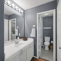 Modern bathroom featuring a spacious vanity, ample lighting, and convenient layout for everyday use.