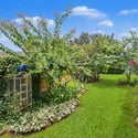 Lush garden oasis features winding pathways, vibrant plants, and a tranquil atmosphere perfect for relaxation.