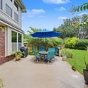 Discover a spacious patio with vibrant landscaping, perfect for outdoor gatherings and relaxation.