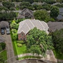 Spacious home nestled in a lush neighborhood, featuring an expansive yard and convenient two-car garage.