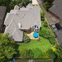 Spacious backyard oasis featuring a vibrant garden and inviting patio, perfect for outdoor gatherings and relaxation.