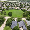 Spacious homes surround a central green space, ideal for outdoor activities and community gatherings.