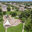 Spacious neighborhood park with playground, walking paths, and ample green space, perfect for family activities.