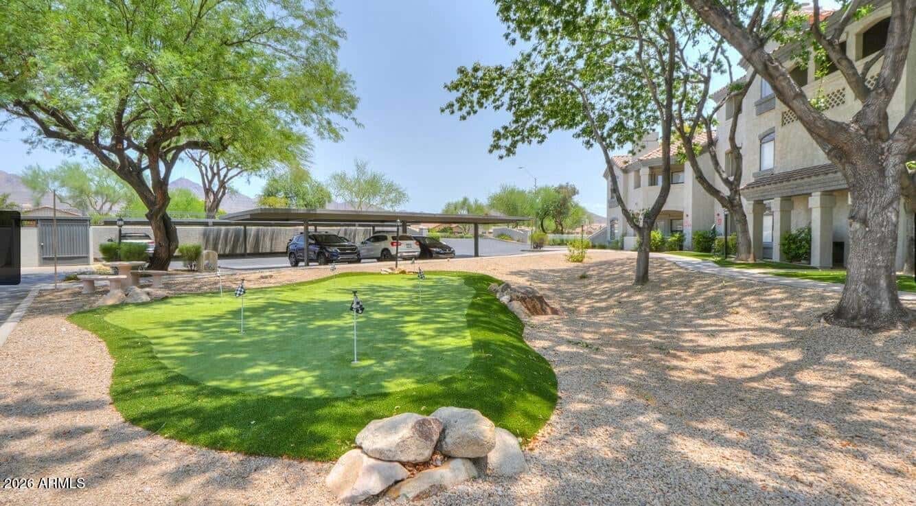 29 of 32. Residents can enjoy a dedicated putting green surrounded by professionally maintained landscaping, providing a fun recreational amenity within this desirable Scottsdale community.