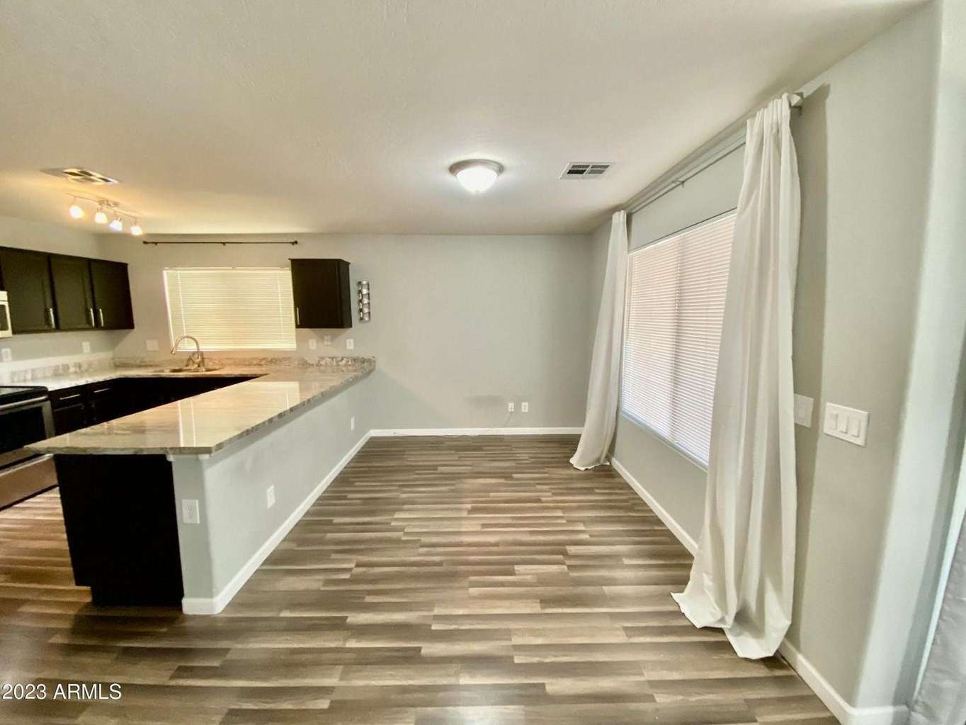 5 of 16. Bright dining space conveniently connected to the kitchen and living areas. Large windows and an open layout create an inviting atmosphere for meals and entertaining.