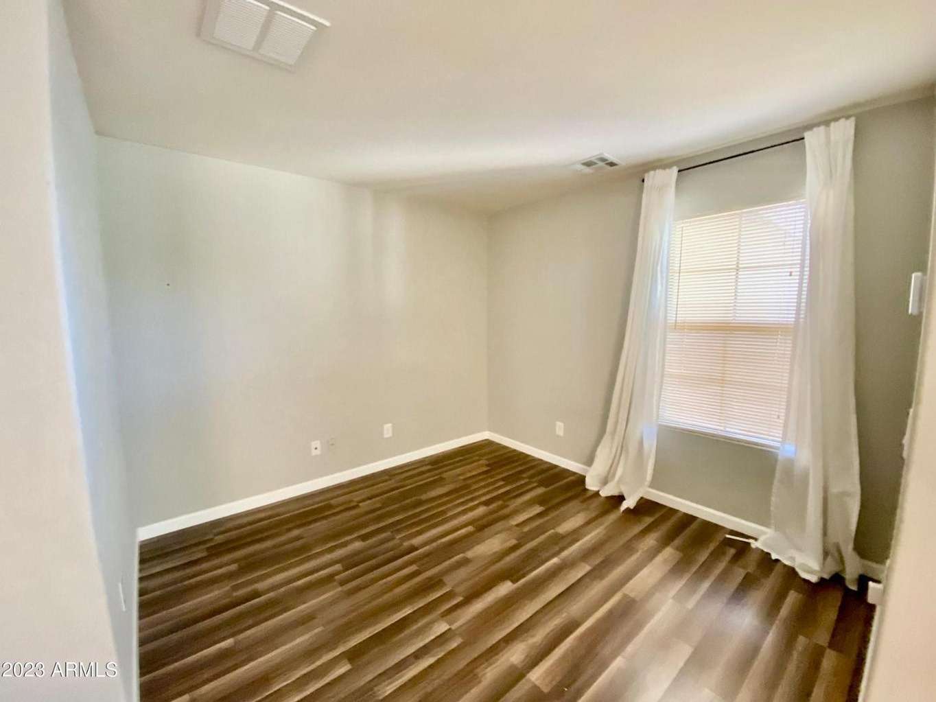 9 of 16. Spacious primary bedroom with plush carpeting, ceiling fan, and calming neutral tones. A peaceful retreat designed for comfort and everyday relaxation.