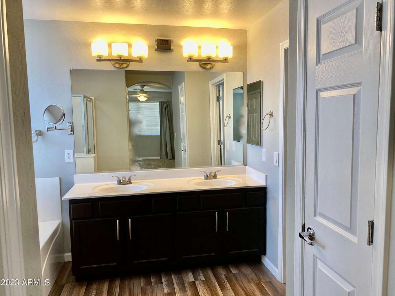 14 of 16. Large dual-sink vanity with abundant counter space, upgraded cabinetry, and modern lighting. This thoughtfully designed bathroom offers convenience and everyday functionality.