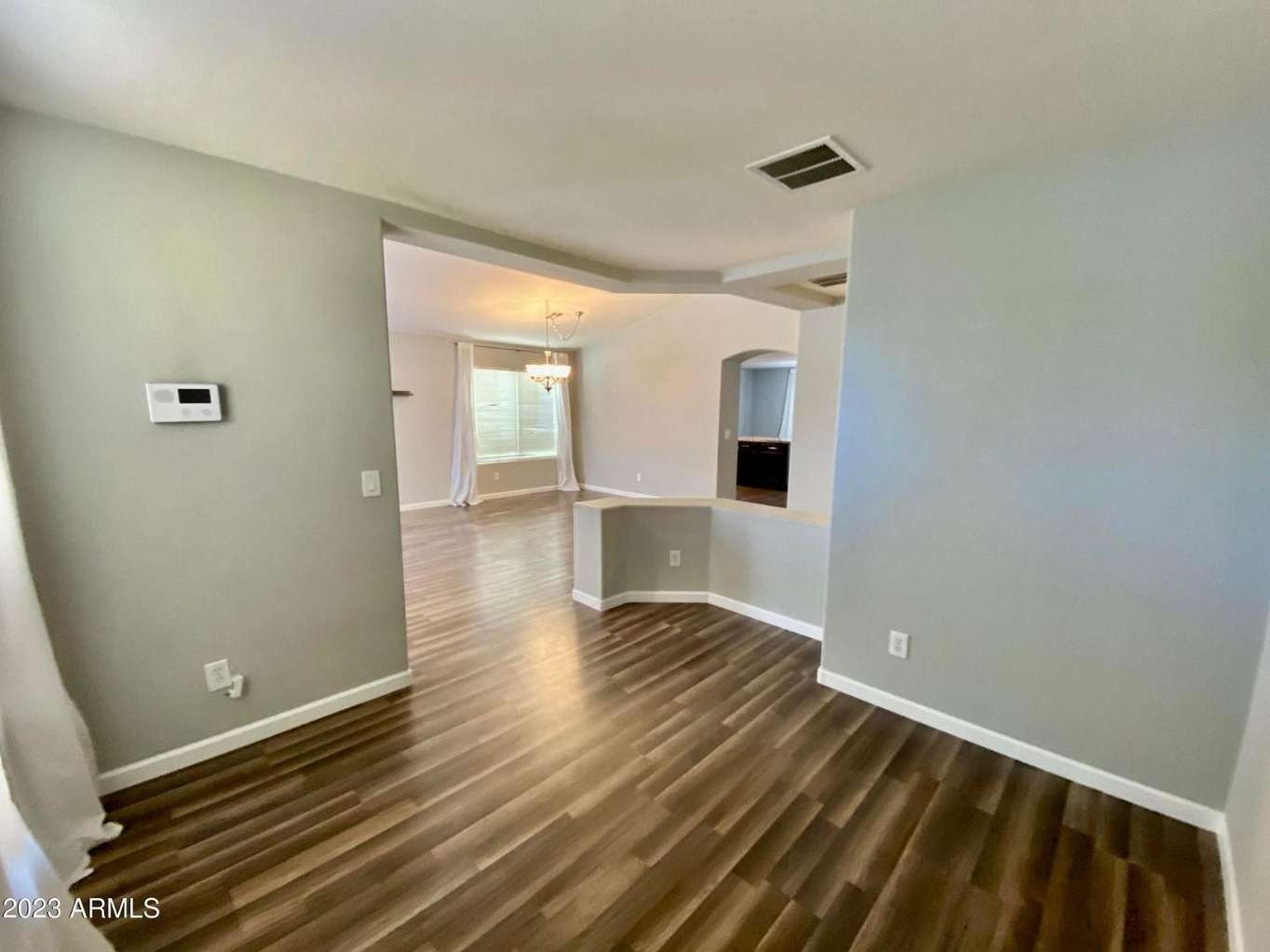 16 of 16. Open flex room with attractive flooring and seamless flow into the main living areas. Perfect for a home office, hobby room, study area, or additional lounge space.