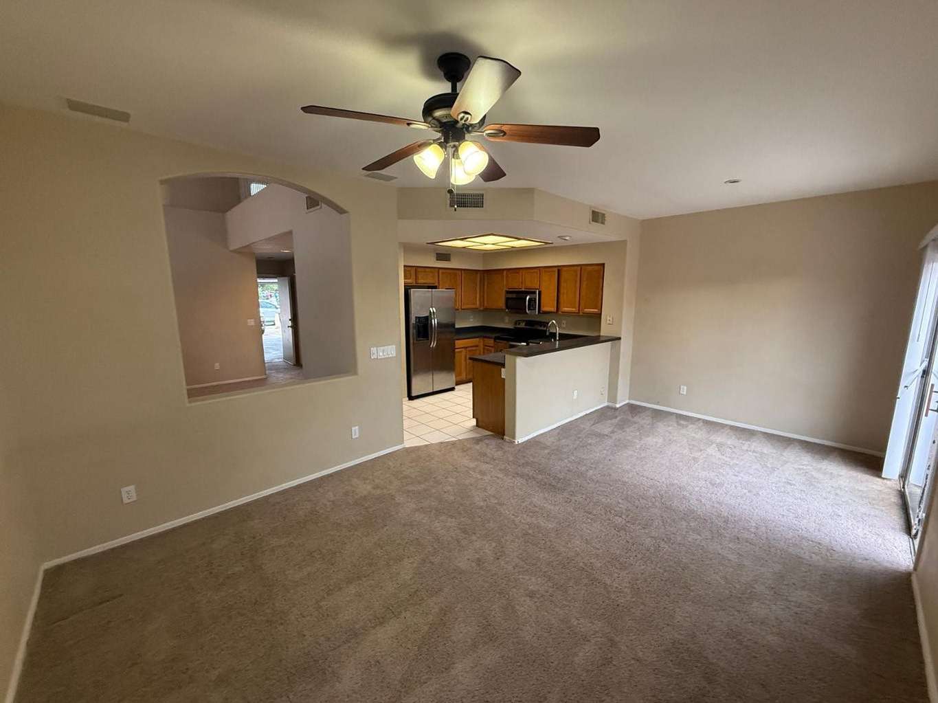 7 of 22. Expansive great room connected to the kitchen for easy entertaining and everyday functionality. Bright windows and an open layout maximize space and comfort.
