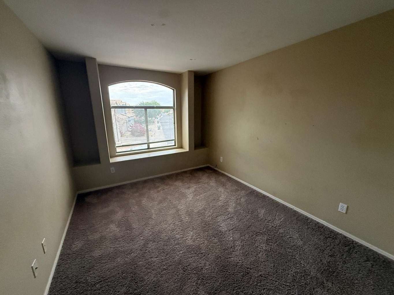 16 of 22. Flexible bonus room with a large arched window, plush carpeting, and built-in media niche. An excellent option for a game room, office, reading area, or entertainment lounge.