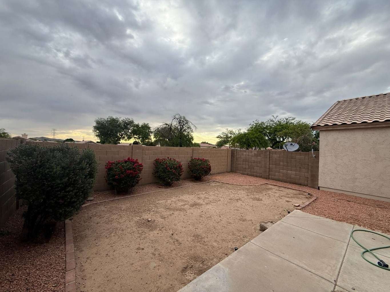 21 of 22. Enjoy a generously sized backyard with desert landscaping, flowering shrubs, and privacy fencing. This versatile outdoor space offers endless possibilities for gardening, recreation, or future outdoor enhancements.
