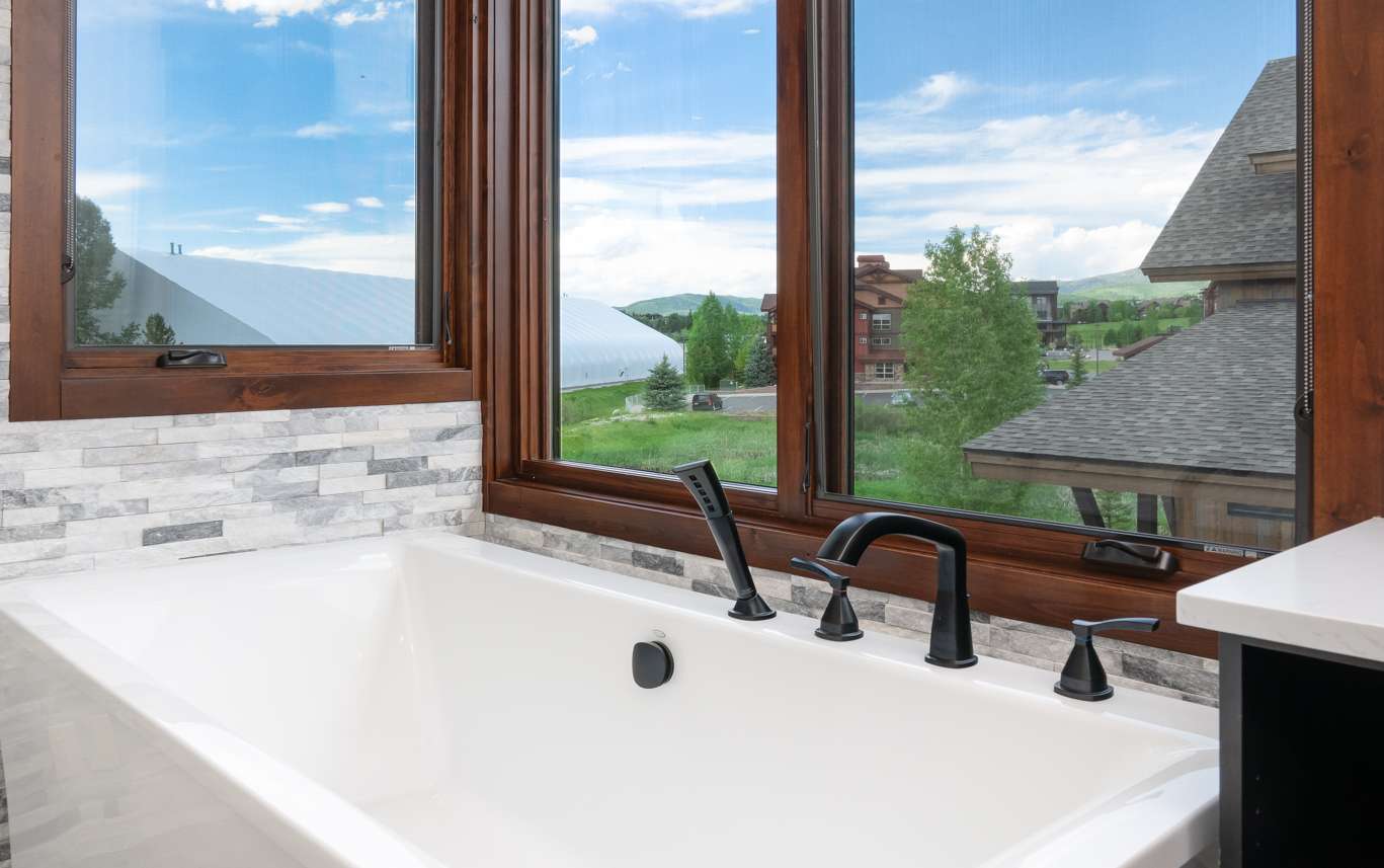 17 of 42. Enjoy breathtaking views from this luxurious freestanding bathtub, perfect for relaxation and tranquility.