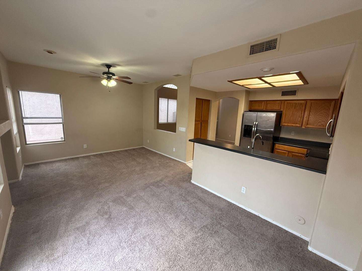 8 of 22. Functional kitchen featuring extensive cabinetry, a breakfast bar, and ample countertop space. Designed to keep you connected to guests while preparing meals.