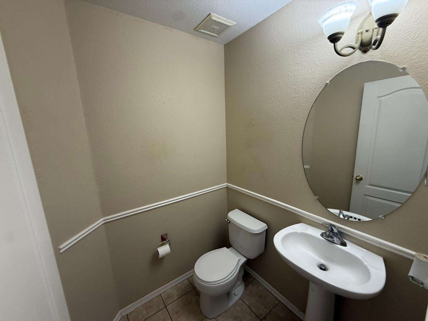 12 of 22. Convenient guest bathroom with pedestal sink, tile flooring, and neutral d cor. Ideally positioned to serve visitors while maintaining privacy for the main living areas.
