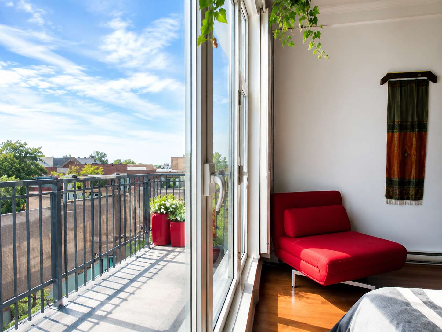 18 of 21. Bright, airy bedroom featuring a spacious balcony, inviting natural light and outdoor views.