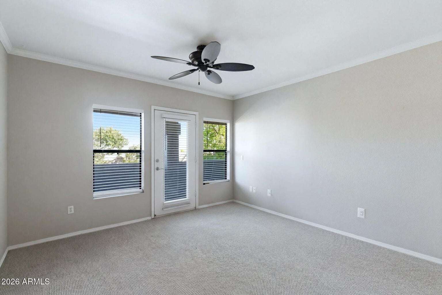 5 of 32. This open living room offers generous space for seating, natural light from multiple windows, and convenient access to the private balcony, blending indoor comfort with outdoor enjoyment.