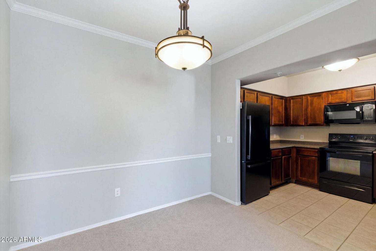 9 of 32. The kitchen and dining area provide an efficient layout with warm wood cabinetry, generous workspace, and modern appliances, creating a practical setting for everyday cooking and entertaining.